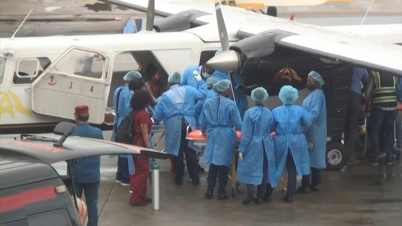 Health workers at Guyana airport treat people injured in school fire | AFP